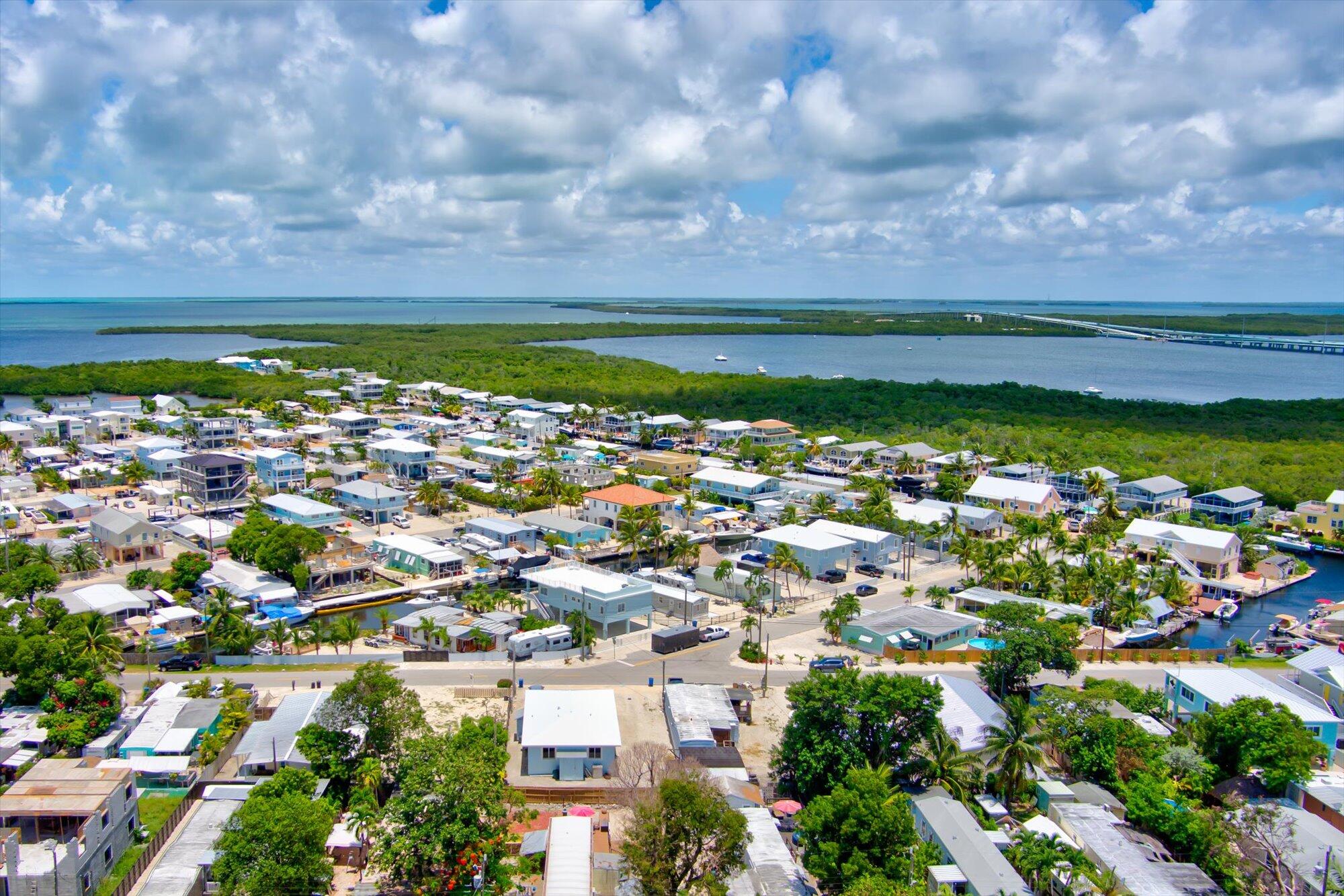 939 Plantation Road Key Largo, FL 33037 - Photo 3 of 38 a view of a city with lots of residential buildings ocean and mountain in back