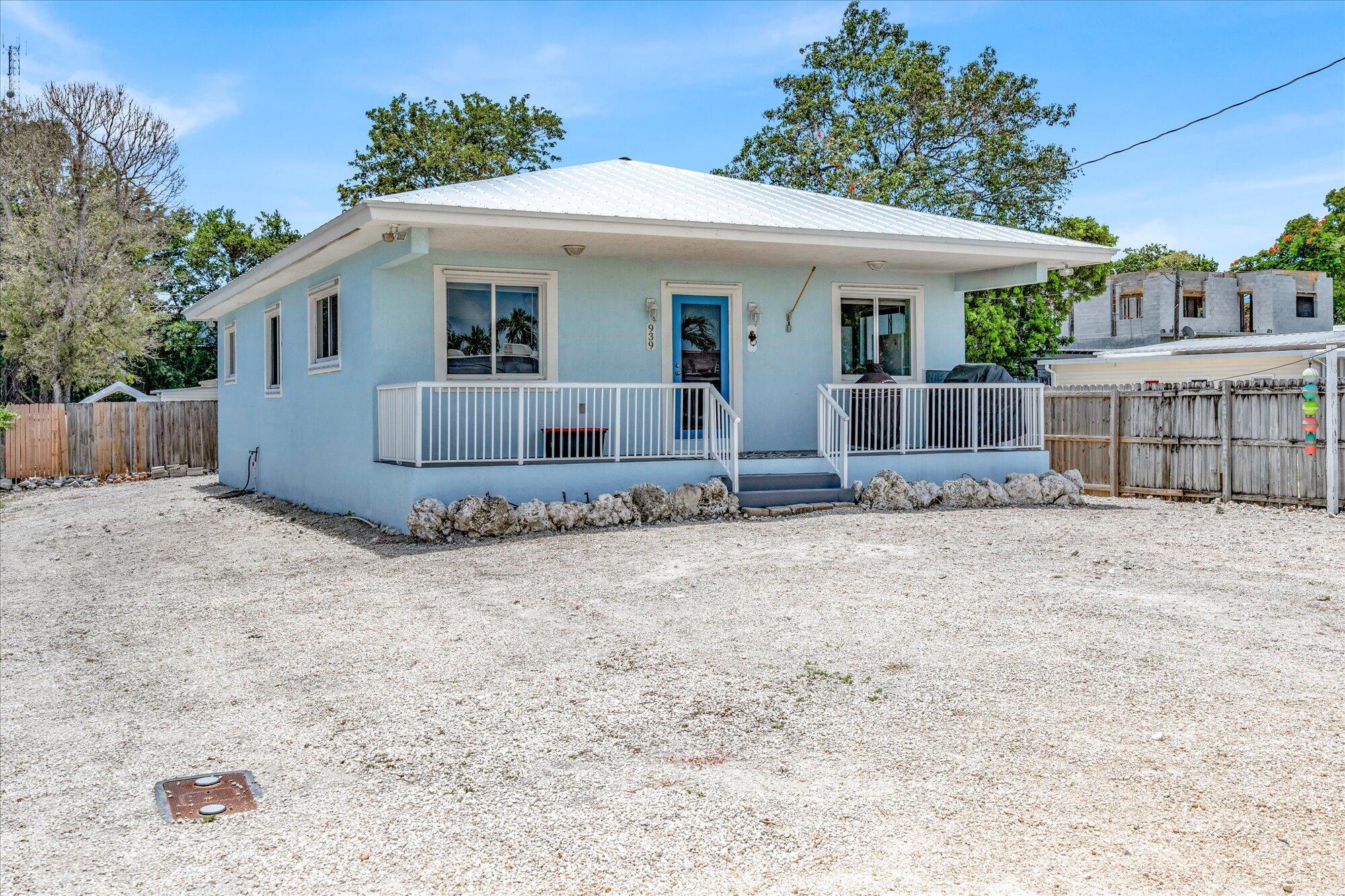 939 Plantation Road Key Largo, FL 33037 - Photo 38 of 38 a view of a white house with a yard and large tree