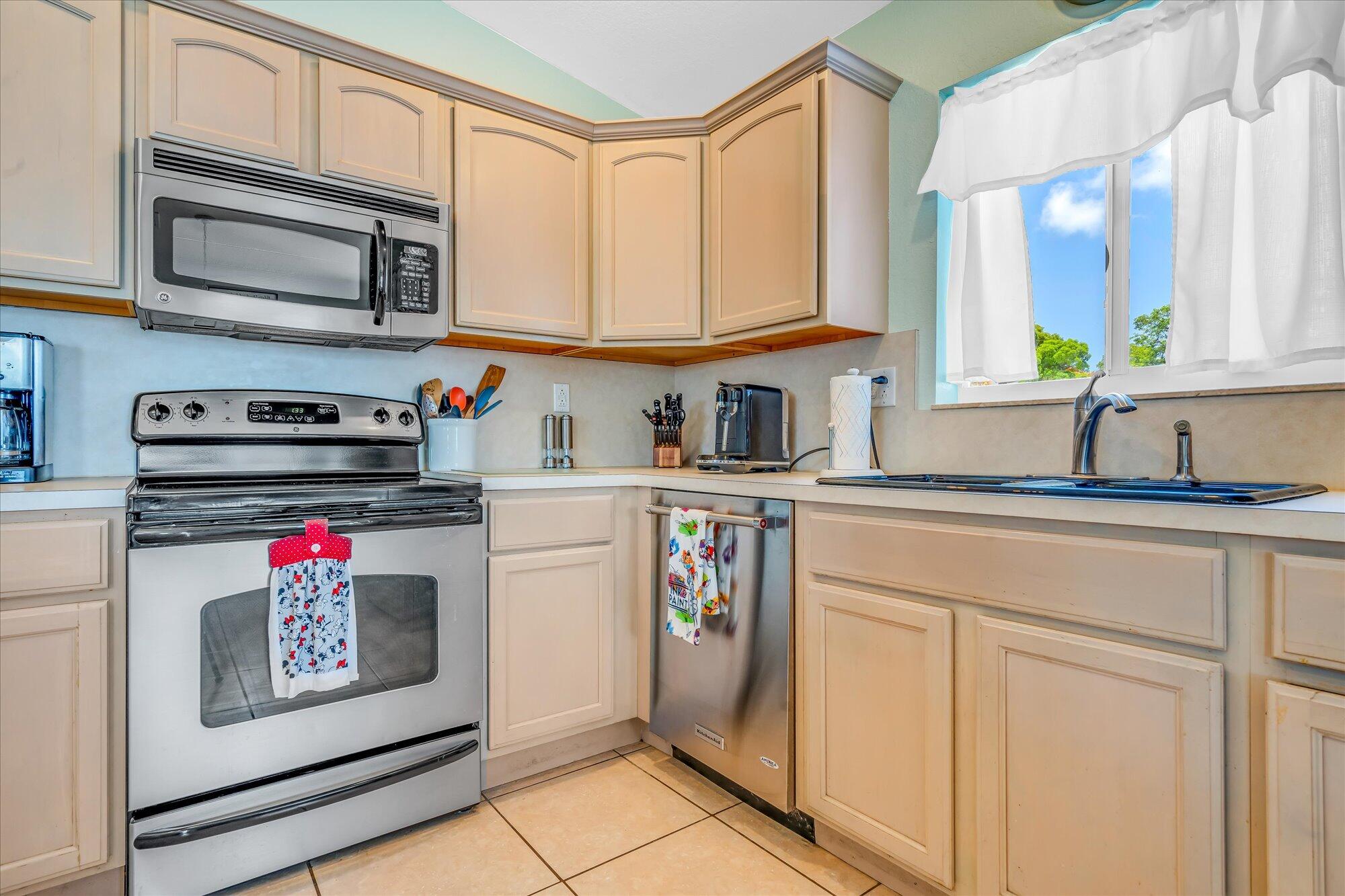 939 Plantation Road Key Largo, FL 33037 - Photo 8 of 38 a utility room with stainless steel appliances granite countertop a sink and a stove