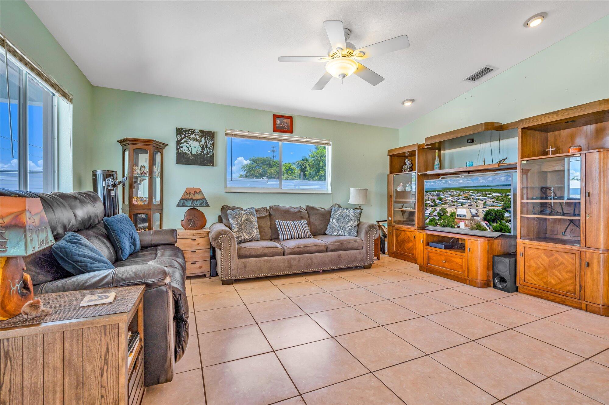 939 Plantation Road Key Largo, FL 33037 - Photo 10 of 38 a living room with furniture and a flat screen tv