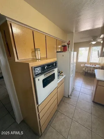 a kitchen that has a sink and a stove top oven