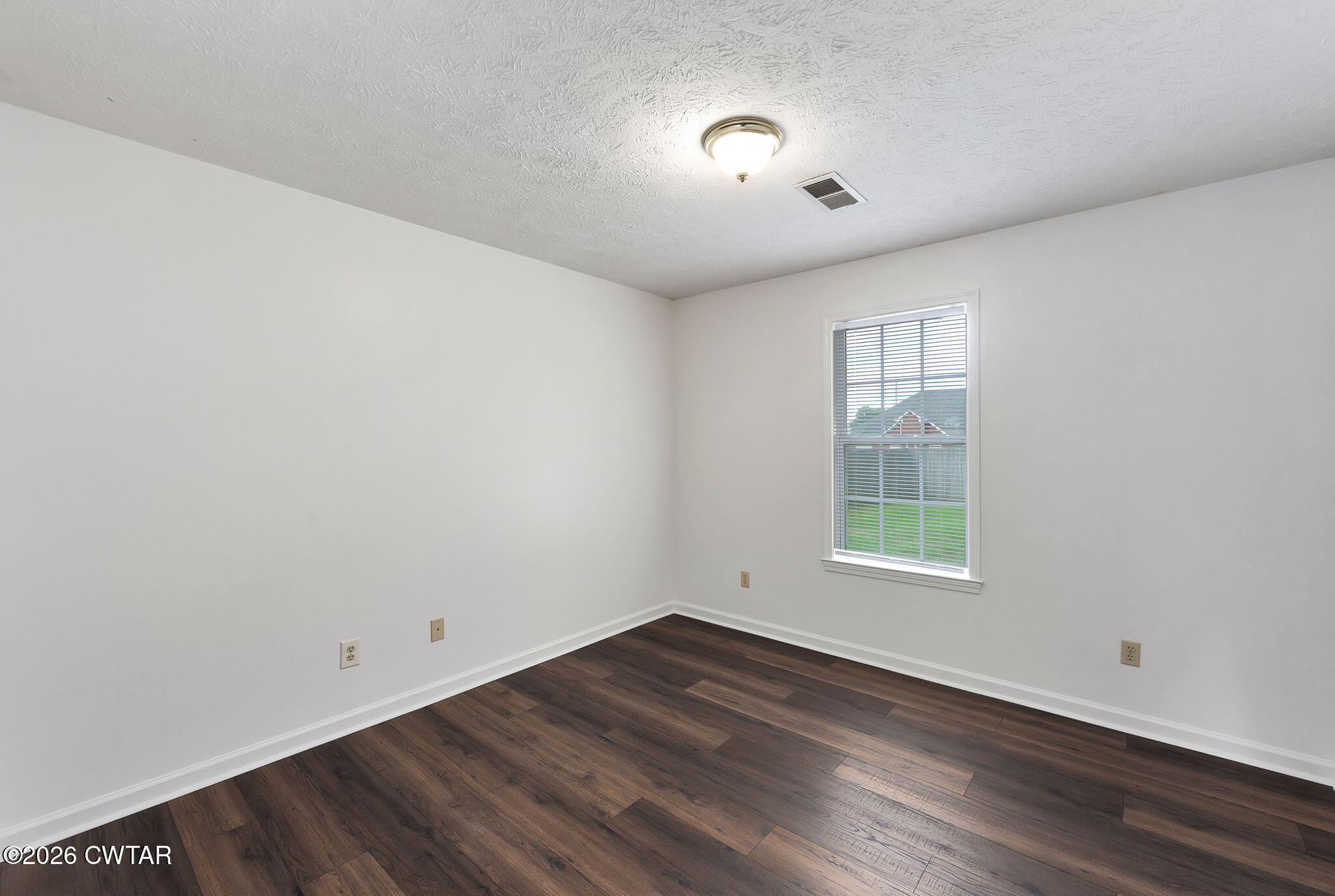 96 Sundown Drive Jackson, TN 38305 - Photo 20 of 28 an empty room with wooden floor and windows