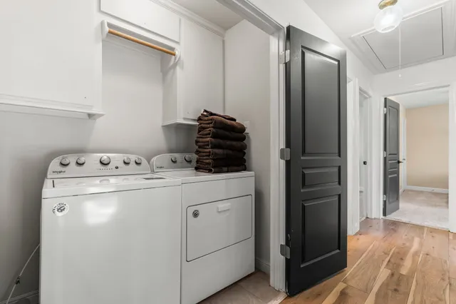 a bedroom with a bed window and a flat screen tv