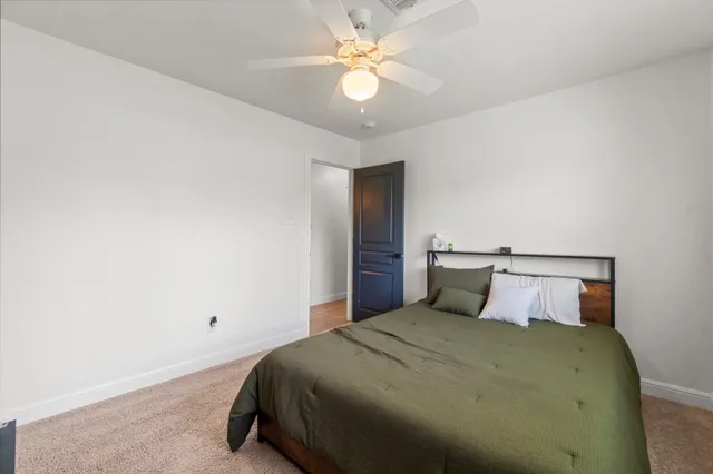 a spacious bedroom with a bed and a large window