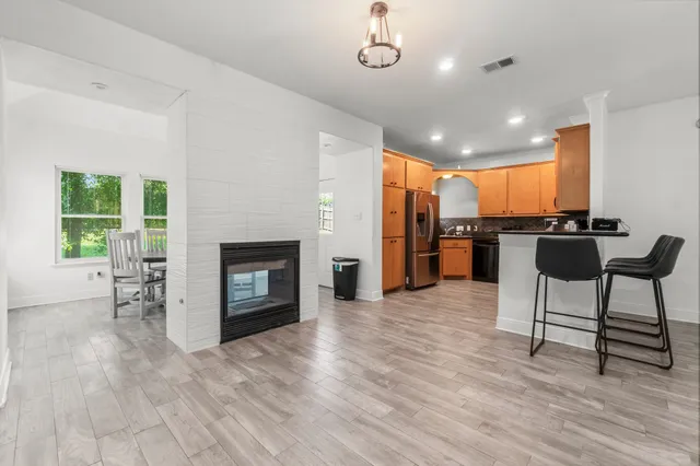 a kitchen with stainless steel appliances granite countertop a refrigerator and a stove top oven