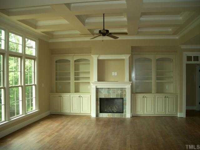 2604 Peachleaf Street, Unit 6025 Raleigh, NC 27614 - Photo 3 of 12 Family room with 12 ft coffered ceiling, fireplace with built-in cabinets and windows overlooking private backyard. Den/Family/Great Room