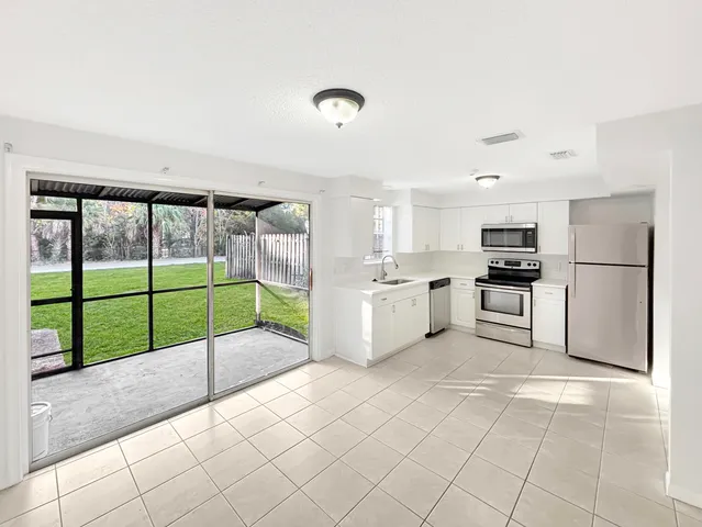 a kitchen with a refrigerator sink and microwave