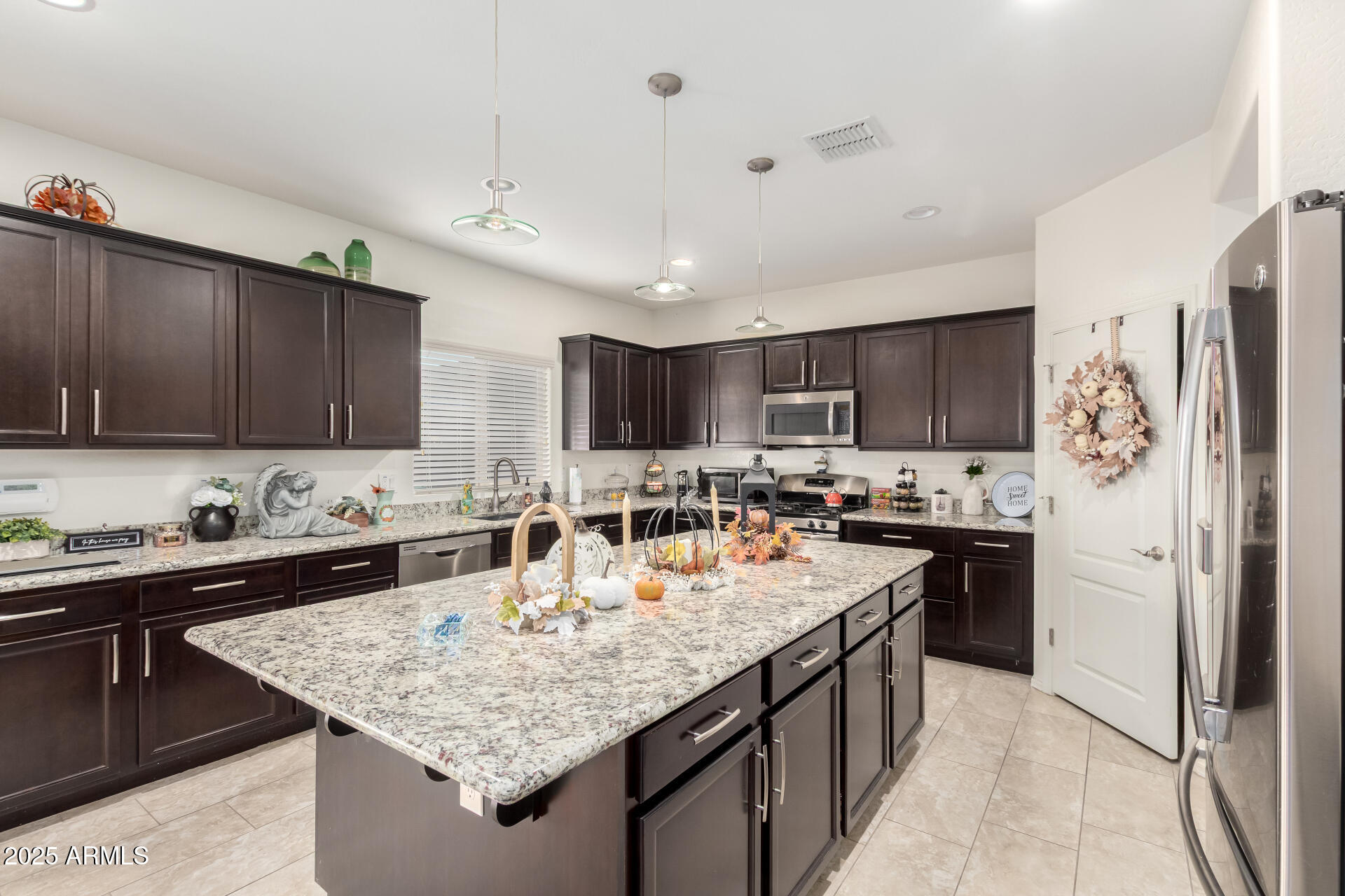 2665 East Gillcrest Road Gilbert, AZ 85298 - Photo 13 of 48 a kitchen with stainless steel appliances granite countertop a sink stove and refrigerator