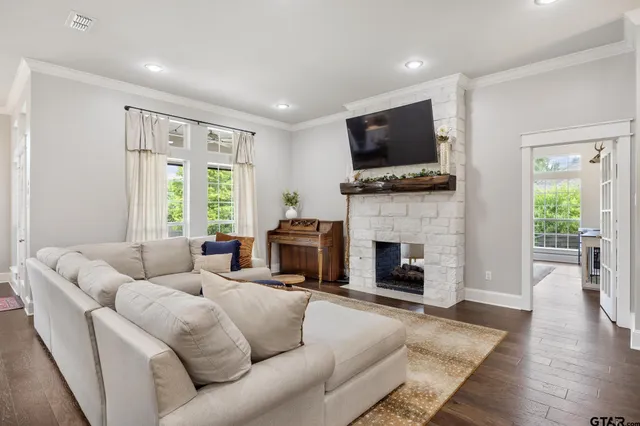 a living room with furniture a flat screen tv and a fireplace