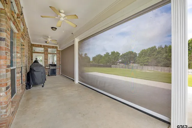 a view of a living room and chandelier fan fire place and a yard