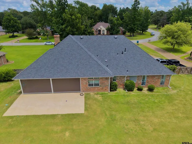 an aerial view of a house with a yard