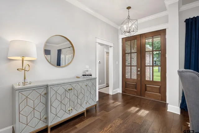 a view of a livingroom with furniture wooden floor and a chandelier