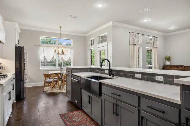a kitchen with stainless steel appliances granite countertop a sink stove and refrigerator