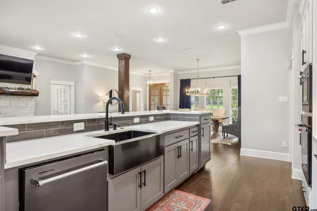 a kitchen with a sink stove and cabinets