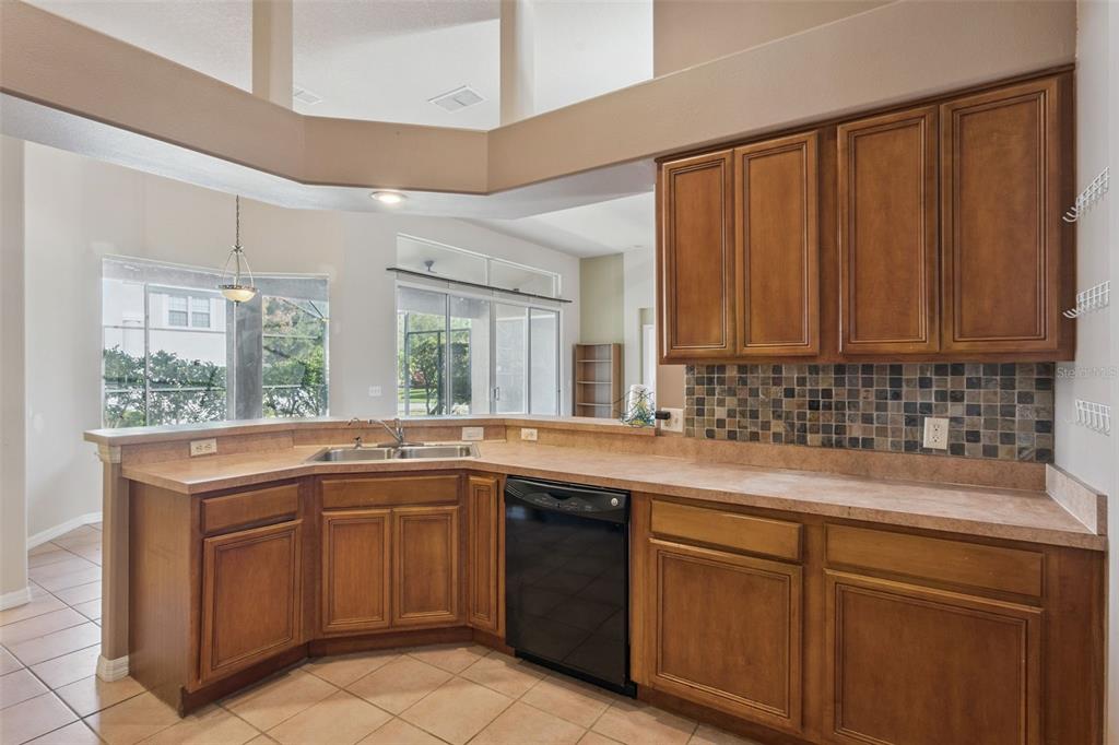 774 Lancer Circle Ocoee, FL 34761 - Photo 15 of 35 a kitchen with a sink stove and cabinets
