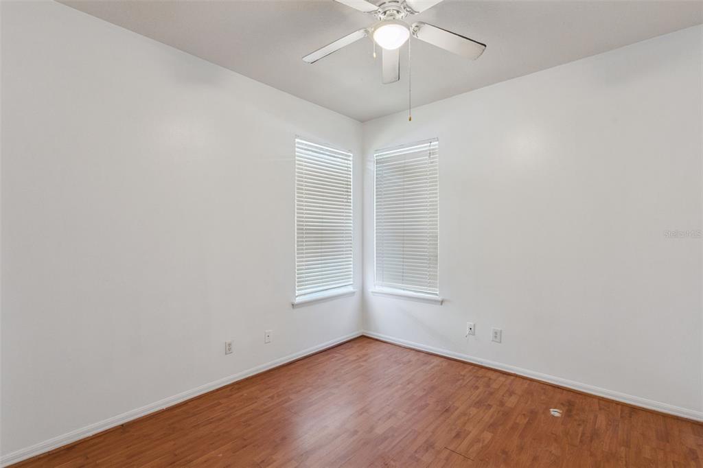 774 Lancer Circle Ocoee, FL 34761 - Photo 19 of 35 an empty room with a chandelier fan and windows