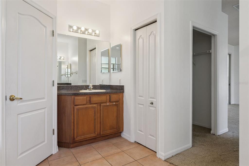 774 Lancer Circle Ocoee, FL 34761 - Photo 27 of 35 a bathroom with a granite countertop sink and a mirror