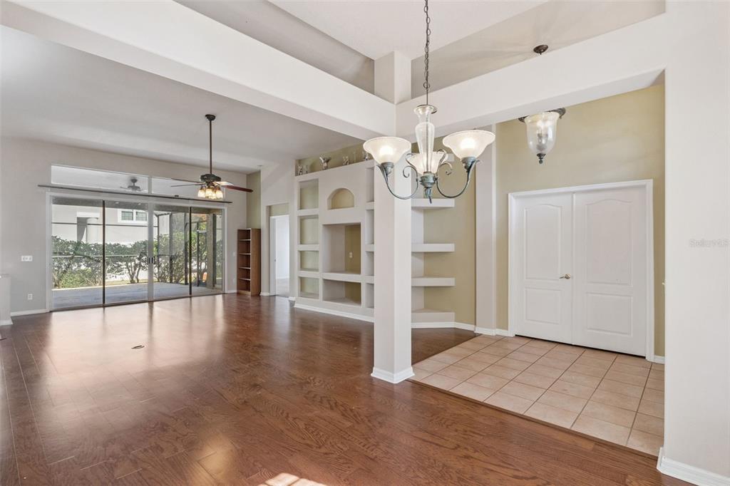 774 Lancer Circle Ocoee, FL 34761 - Photo 9 of 35 an empty room with wooden floor chandelier and windows