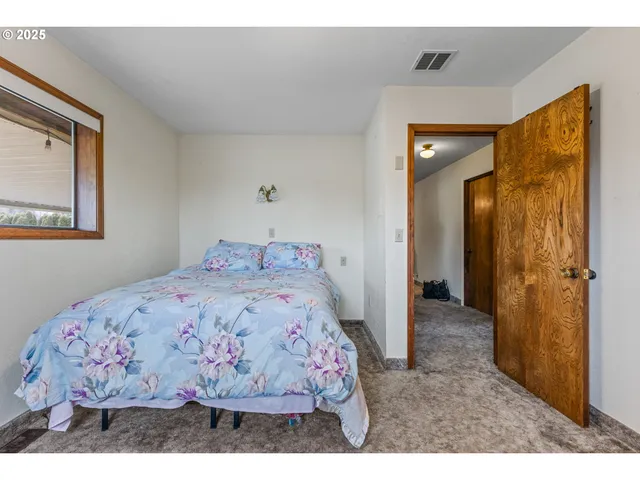 a bedroom with a bed and a mirror