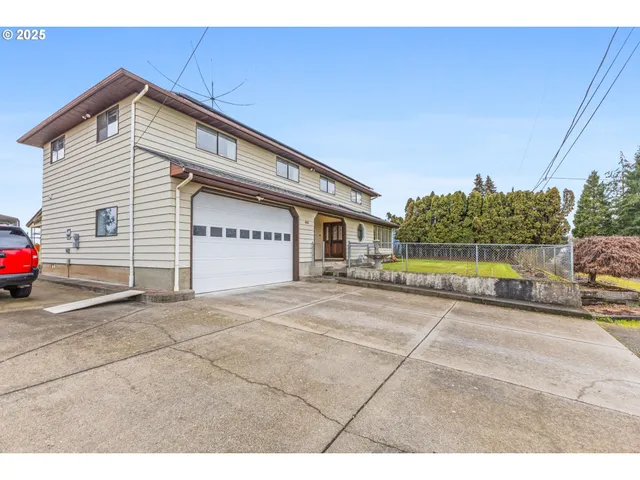 a view of a house with a yard and garage
