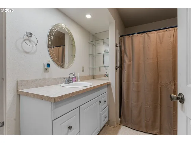 a spacious bedroom with a bed and a chandelier