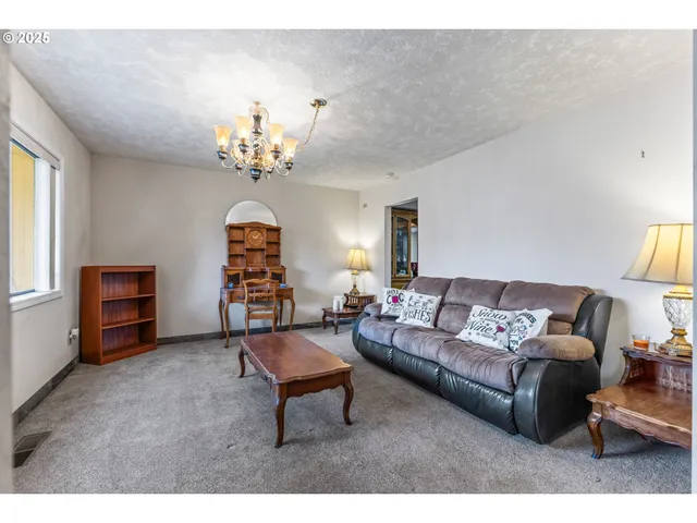 a living room with furniture a chandelier and a chandelier