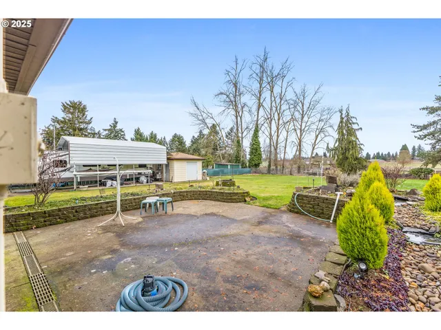 a view of yard with swimming pool and trees