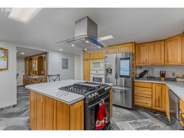 a kitchen with stainless steel appliances granite countertop a sink stove and refrigerator