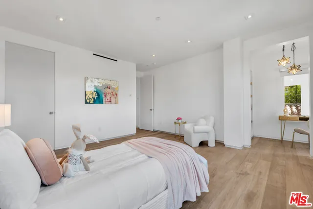 a bedroom with a bed and a couch