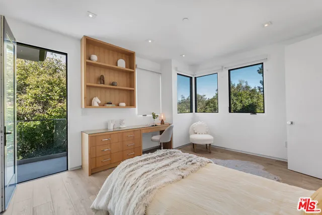 a bedroom with a bed and large window