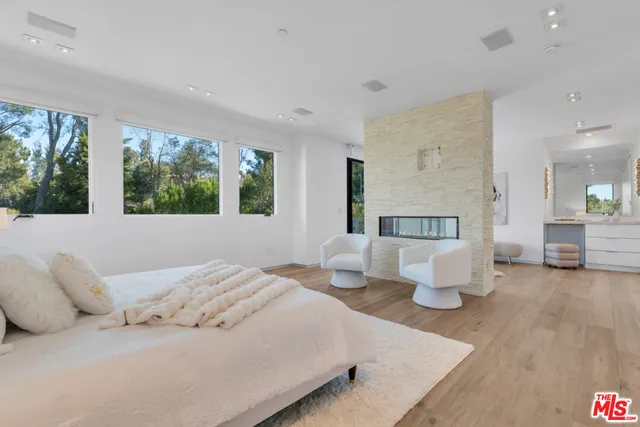 a bedroom with a large bed and a couch