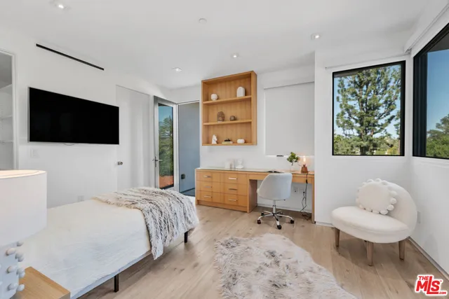 a bedroom with a bed and a flat screen tv