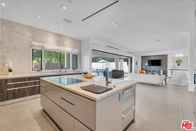 a view of kitchen with stainless steel appliances granite countertop sink and window