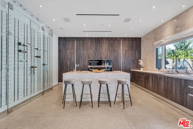 a view of a chairs in a room with a large window