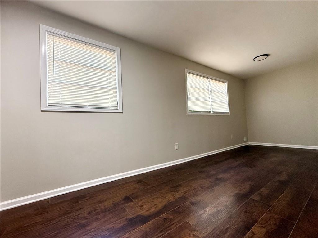1910 Wildwood Drive Decatur, GA 30032 - Photo 12 of 17 an empty room with wooden floor and windows