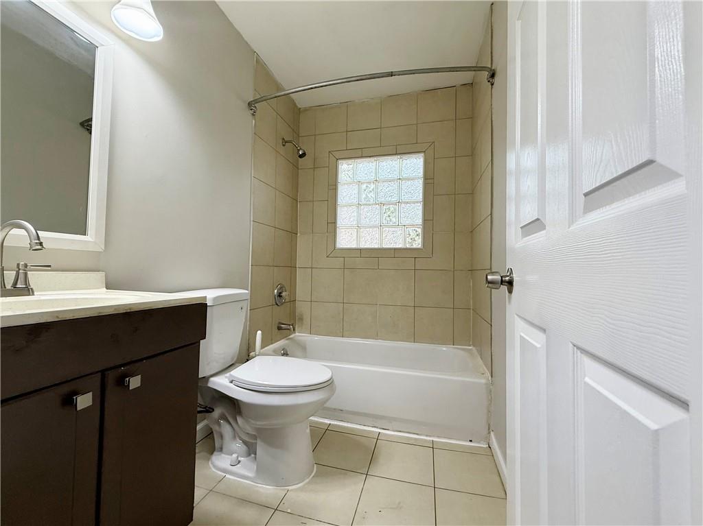 1910 Wildwood Drive Decatur, GA 30032 - Photo 9 of 17 a bathroom with a sink a toilet and shower