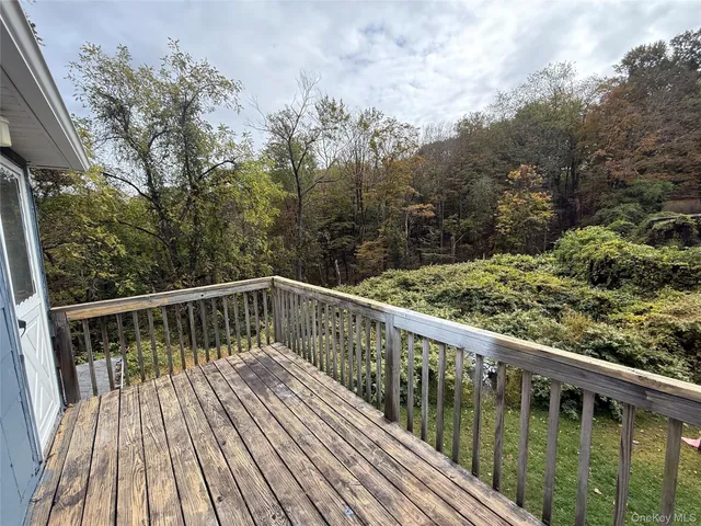 a balcony with wooden floor and fence