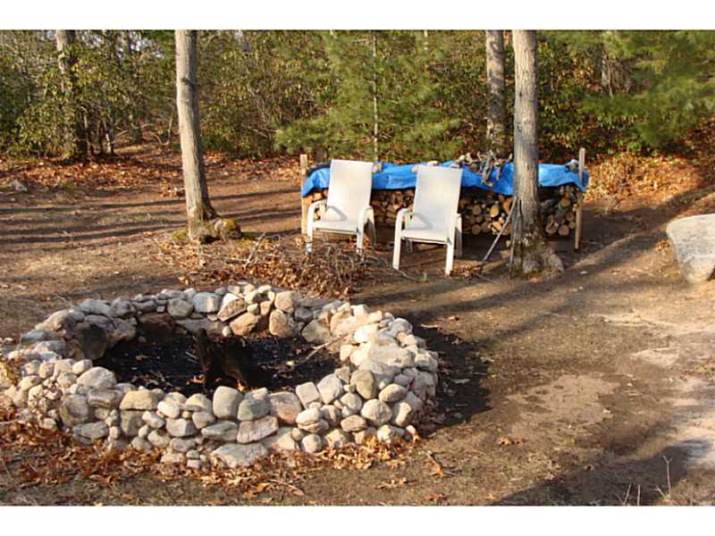 168 Black Pond Road Charlestown, RI 02813 - Photo 17 of 25 Yard/Garden. Fire pit in the back of the property