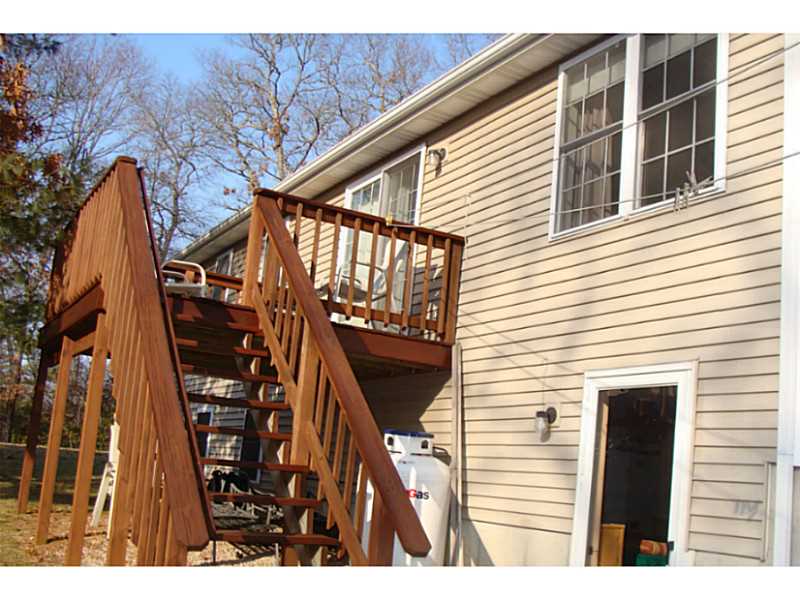 168 Black Pond Road Charlestown, RI 02813 - Photo 18 of 25 Exterior Back. deck and door from walk out lower level