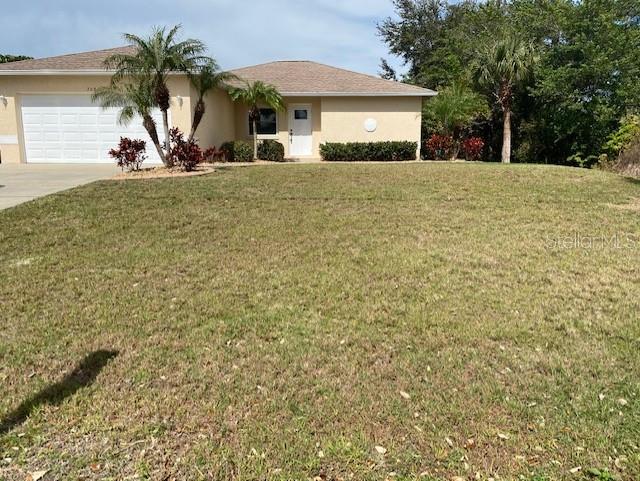 a view of a house with a yard and garage