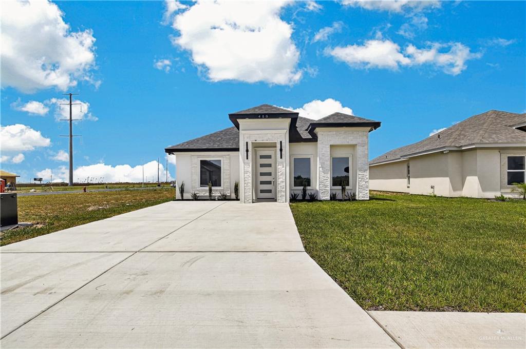 450 Sandy Road Donna, TX 78537 - Photo 2 of 15 Modern facade featuring white stacked stone accents and dark trim