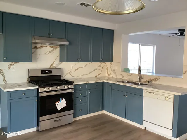 a kitchen with a stove and a sink