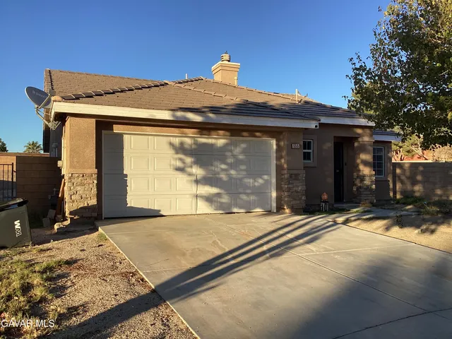a view of a house with a snow in the yard