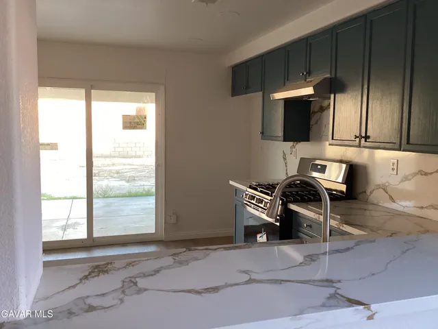 a view of a livingroom with furniture and a window