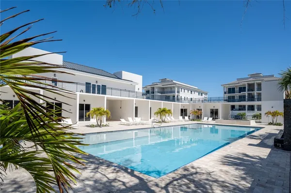 a view of a swimming pool with a lounge chairs