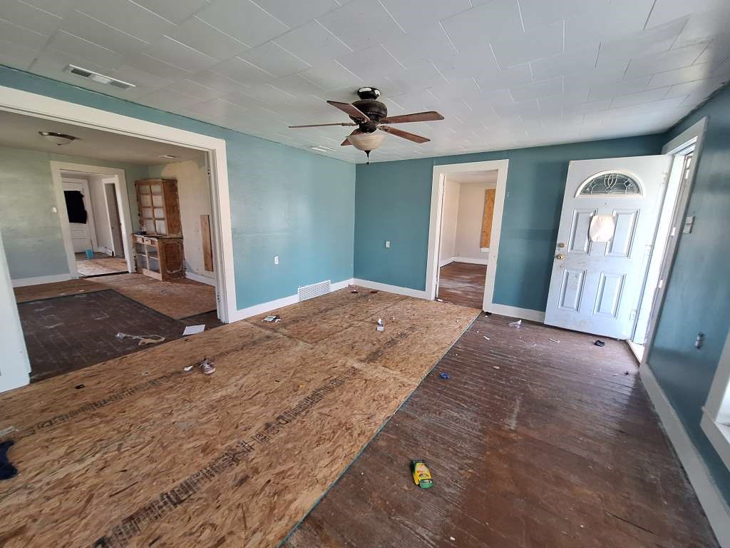 202 Phillips Street Arp, TX 75750 - Photo 5 of 8 a bedroom with a bed and a chandelier
