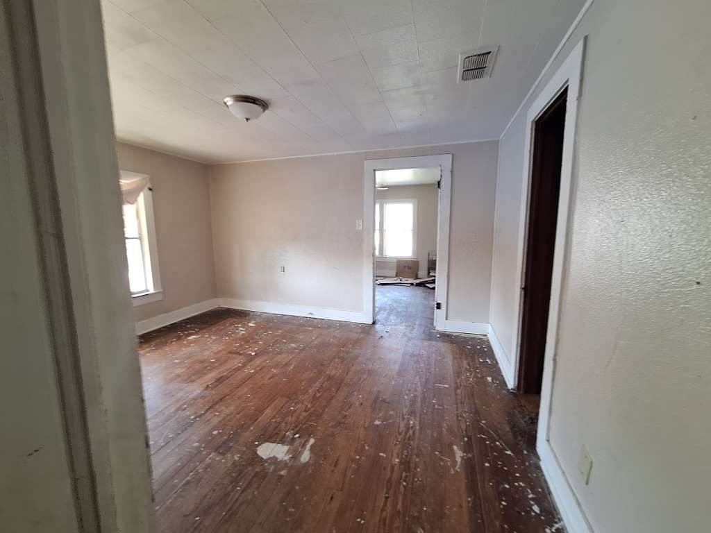 202 Phillips Street Arp, TX 75750 - Photo 6 of 8 wooden floor in an empty room with a window
