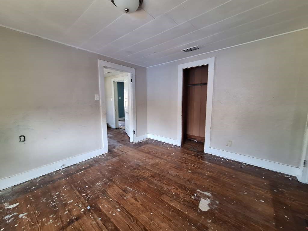202 Phillips Street Arp, TX 75750 - Photo 7 of 8 a view of an empty room with wooden floor and closet