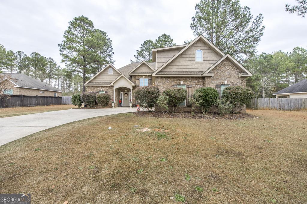 312 Bridgehampton Way Perry, GA 31069 - Photo 1 of 34 a house with trees in the background