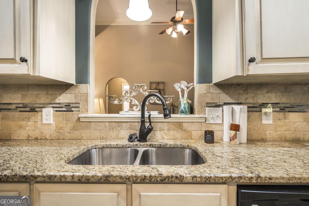 312 Bridgehampton Way Perry, GA 31069 - Photo 15 of 34 a kitchen with granite countertop a sink stainless steel appliances and cabinets